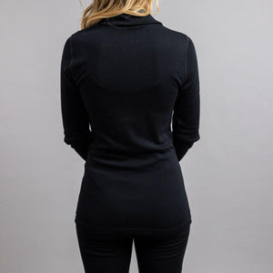 Back view of a person wearing a black long sleeve shirt with a collar
