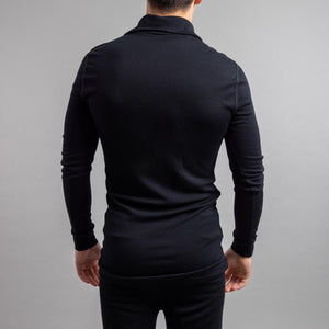 Back view of a man wearing a black Merino Skins long sleeve base layer top