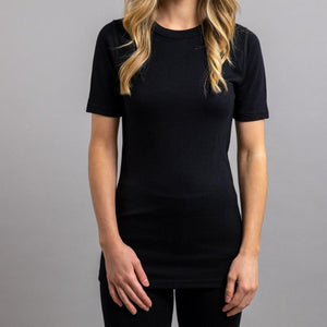 Woman wearing a black Merino Skins short sleeve crew neck shirt