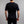 Back view of a man wearing a black Merino Skins short sleeve crew neck t-shirt