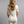 Back view of a woman wearing a Merino Skins cream short sleeve t-shirt