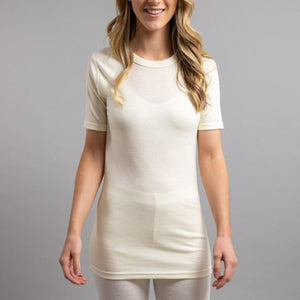 Woman wearing a cream Merino Skins short sleeve crew neck base layer top