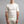 Man wearing a cream Merino Skins short sleeve crew neck base layer shirt