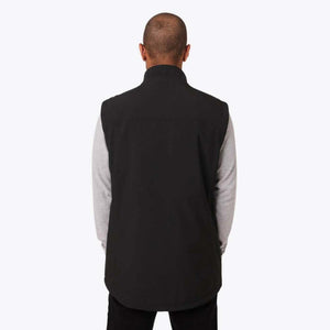 Back view of a person wearing a black Mobile Warming vest over a grey long sleeve shirt