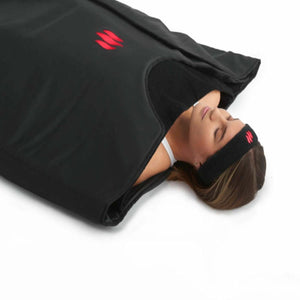 Person lying inside a black MiHigh infrared sauna blanket