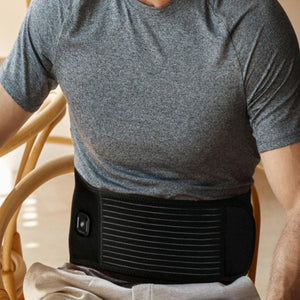 Person wearing a black MiHigh heated waist belt over a grey t-shirt