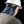 Worker wearing a white hard hat with a blue neck shade attachment