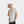Man wearing a white Mission bucket hat and a light grey short sleeve button down shirt
