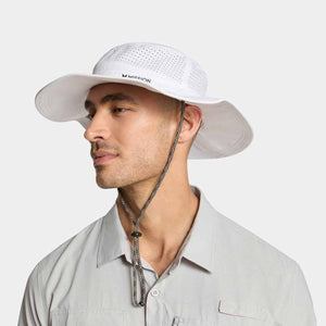 Man wearing a white Mission wide brim sun hat with a chin strap