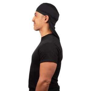 Man wearing a black Mission cooling skull cap from the side