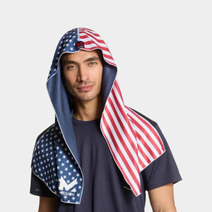 Man wearing a Mission cooling towel with an American flag print over his head