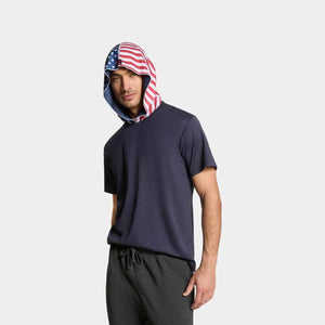 Man wearing a navy Mission t-shirt with an American flag print hood