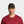 Man wearing a black Mission baseball cap and a maroon crew neck shirt
