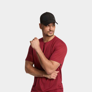 Man wearing a black baseball cap and a maroon t-shirt