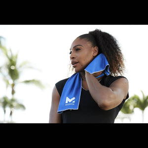 Woman using a blue Mission cooling towel around her neck