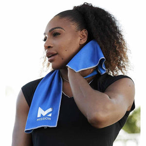 Woman using a blue Mission cooling towel around her neck