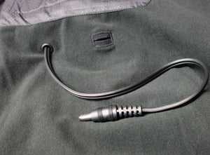 Black power cable with a barrel connector extending from a fabric garment