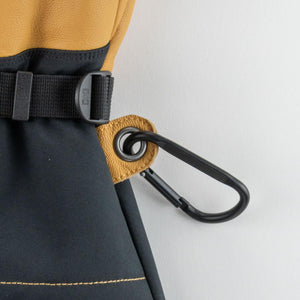 Mobile Warming glove detail showing black carabiner attached to tan leather eyelet
