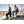 Two people sitting on Mobile Warming heated seat cushions on stadium bleachers