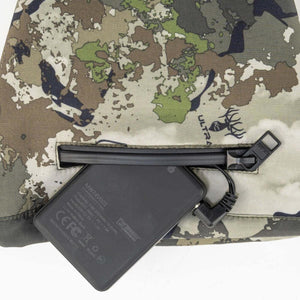 Mobile Warming battery pack connected to a zippered pocket on camouflage fabric