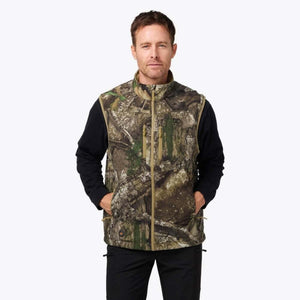 Man wearing a Mobile Warming camouflage heated vest over a black long sleeve shirt