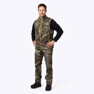 Man wearing Mobile Warming camouflage vest and pants over a black long sleeve shirt