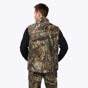 Back view of a man wearing a Mobile Warming camouflage vest over a black long sleeve shirt