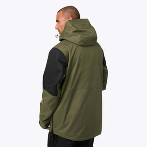 Man wearing olive green and black Mobile Warming hooded jacket from back view