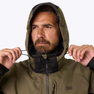Man wearing a Mobile Warming olive green hooded jacket with black accents