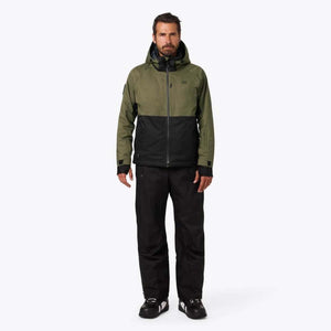 Man wearing a Mobile Warming olive and black hooded jacket with black pants
