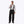 Man wearing Mobile Warming black snow pants with suspenders and a grey long sleeve shirt
