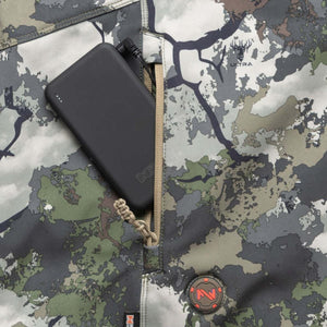 Black power bank inside a zippered pocket of a camouflage patterned Ultra jacket
