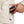 Hand placing a Mobile Warming battery pack into a jacket pocket