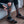 Person inserting a Mobile Warming battery pack into the pocket of a grey and black heated sock