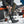 Person wearing Mobile Warming heated socks and black rubber boots while sitting on a snowmobile