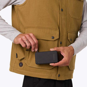Person connecting a Mobile Warming battery pack to a heated vest pocket