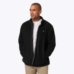 Man wearing a black Mobile Warming fleece jacket with a white shirt underneath