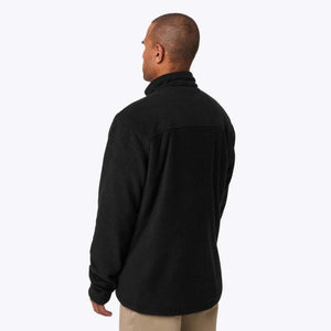 Back view of a man wearing a black Mobile Warming fleece jacket