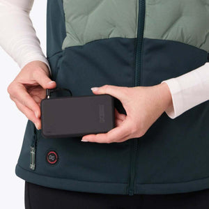 Person connecting a Mobile Warming battery pack to a heated vest