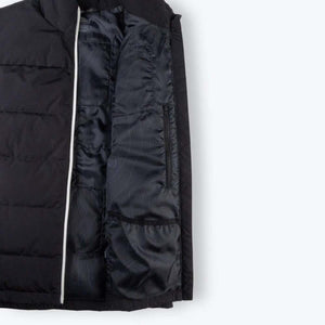 Interior view of black Mobile Warming vest showing lining and zippered pocket