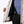 Interior view of a Mobile Warming white patterned ski jacket showing black lining and suspender straps