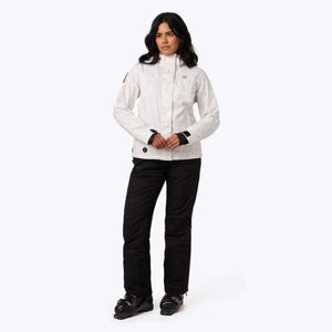 Mobile Warming white patterned ski jacket and black ski pants on a person wearing ski boots