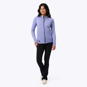 Woman wearing a purple Mobile Warming long sleeve zip up hoodie and black pants