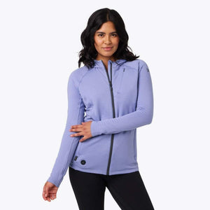 Woman wearing a purple Mobile Warming hooded zip up jacket with a textured fabric