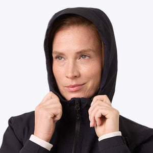 Woman wearing a black Mobile Warming hooded jacket