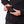 Hands placing a Mobile Warming battery pack into a jacket pocket