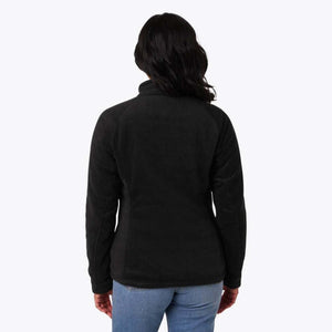 Back view of a woman wearing a black Mobile Warming fleece jacket with blue jeans