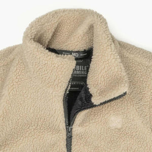 Beige Mobile Warming fleece jacket collar with interior brand label and zipper