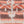 Mobile Warming fleece fabric with a peach and brown geometric pattern and a white center zipper