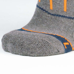 Close up of grey Mobile Warming sock toe with orange and blue accents